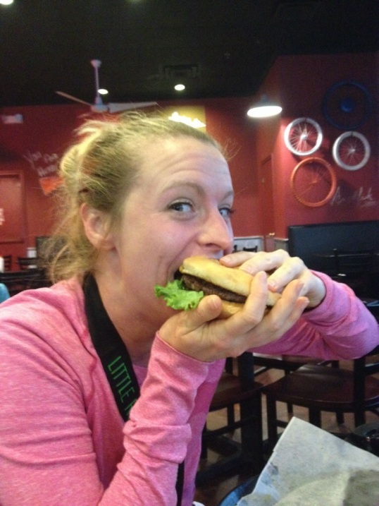 Ashley handles a big ol burger with bacon